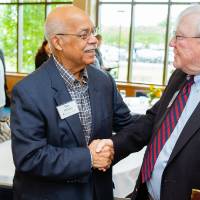President Emeritus Don Lubbers shaking hands with a guest at the Retiree Reception.